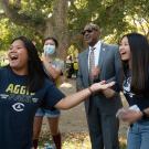 Students take selfies with Chancellor Gary S. May.