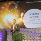 Distinguished Professor Simon Cherry delivers lecture in front of title slide, "A Matter of Time"