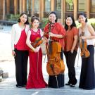 Group of performers wearing red