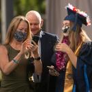 Student talks with parents at commencement.