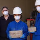 Students and professor display wildfire-resistant bricks