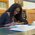 Woman studies iat library table