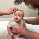 Baby sitting on examination table