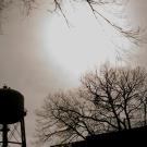 Silhouette of UC Davis Water Tower with sun shining in the background