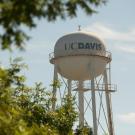 UC Davis water tower wtih leafy trees in the foreground