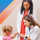 2 people in lab coats/medical setting, examing girl's hand