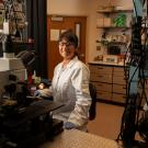 A student smiles in the lab. 