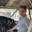 Bethany Baldwin-Pulcini sits in the cockpit of a rocket. 