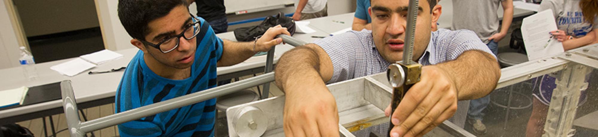 UC Davis civil and environmental engineering graduate student Kaveh Zamani, right, showing a student how to use an instrument