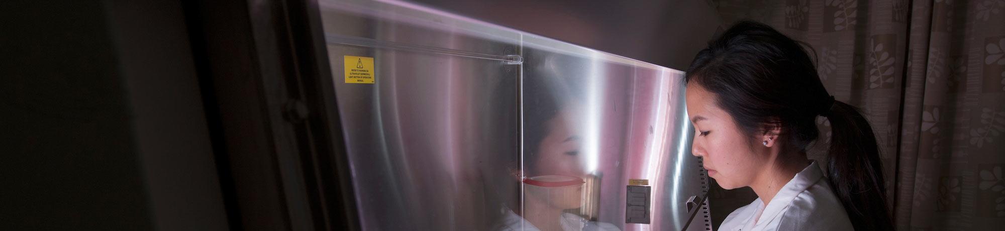 A student in a lab works with samples