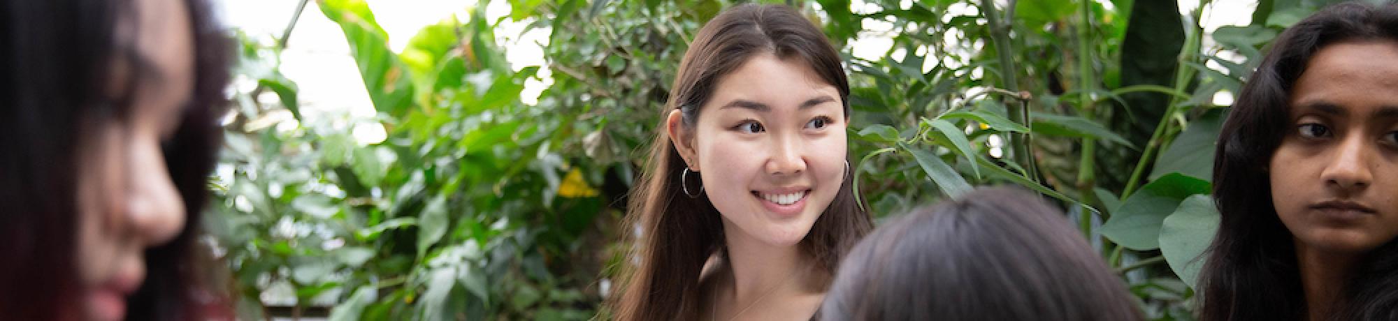 Students smile in a botanical garden at UC Davis. 