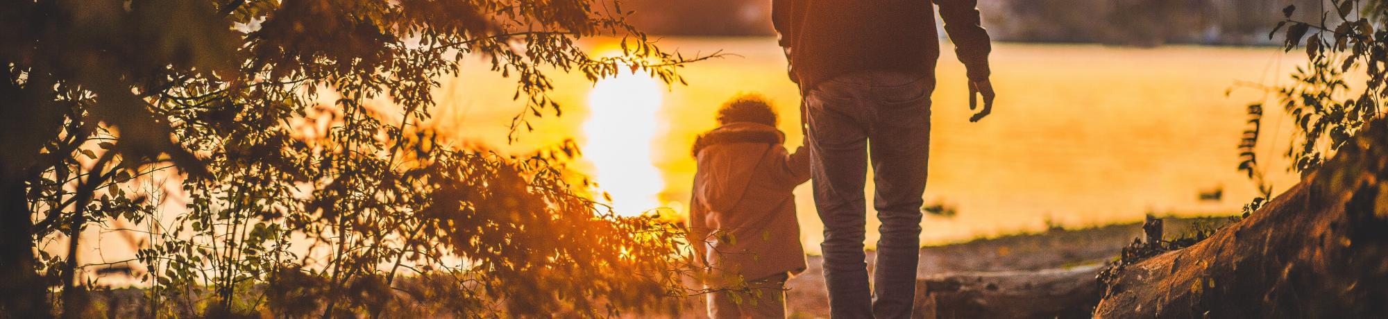 adult walks with young child hand in hand