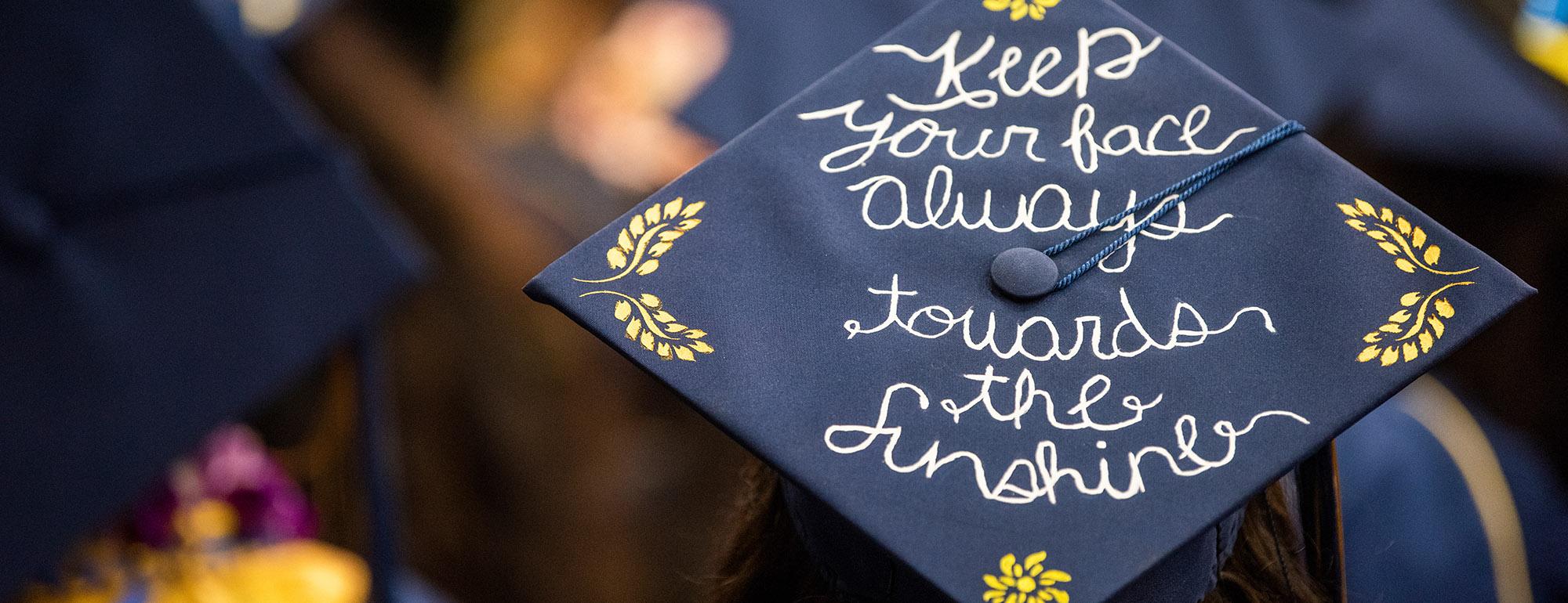 uc davis student at commencement with unique grad cap