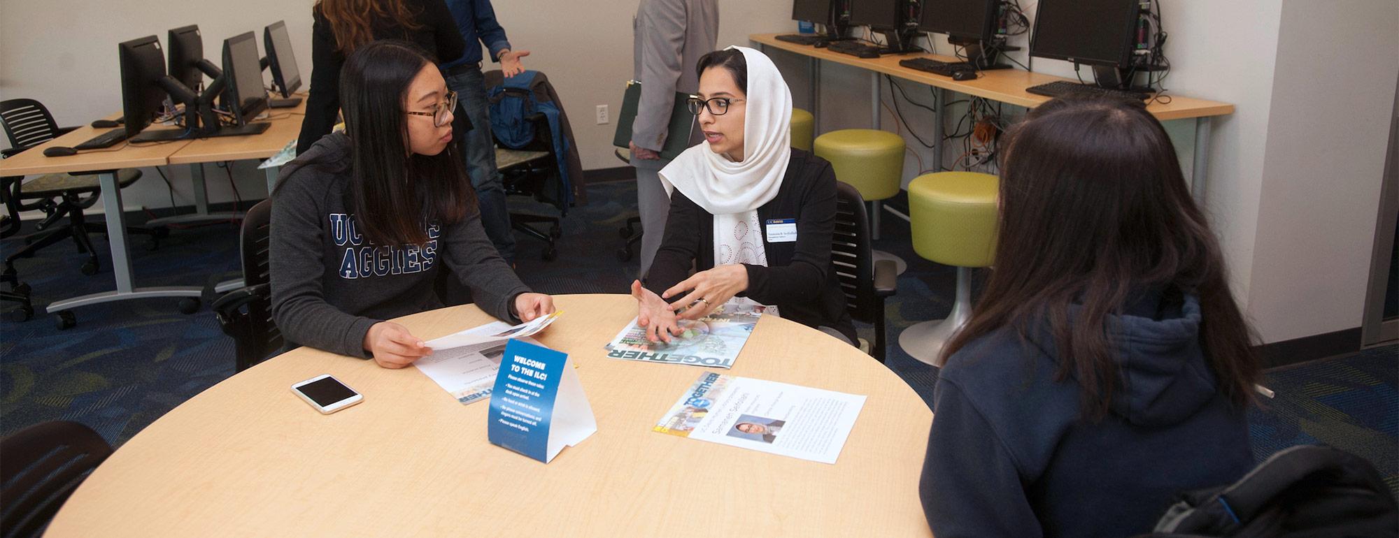 three international students chatting in the international center