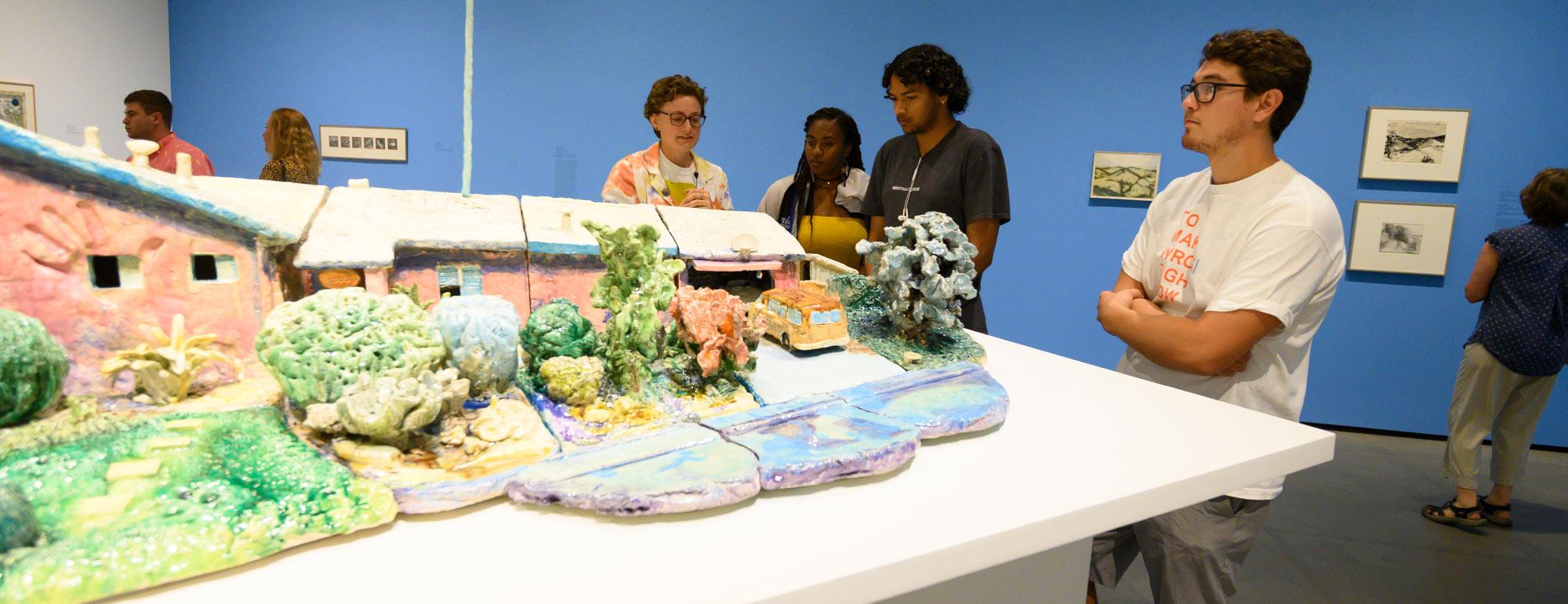 several students looking at art in the Manetti Shrem museum 