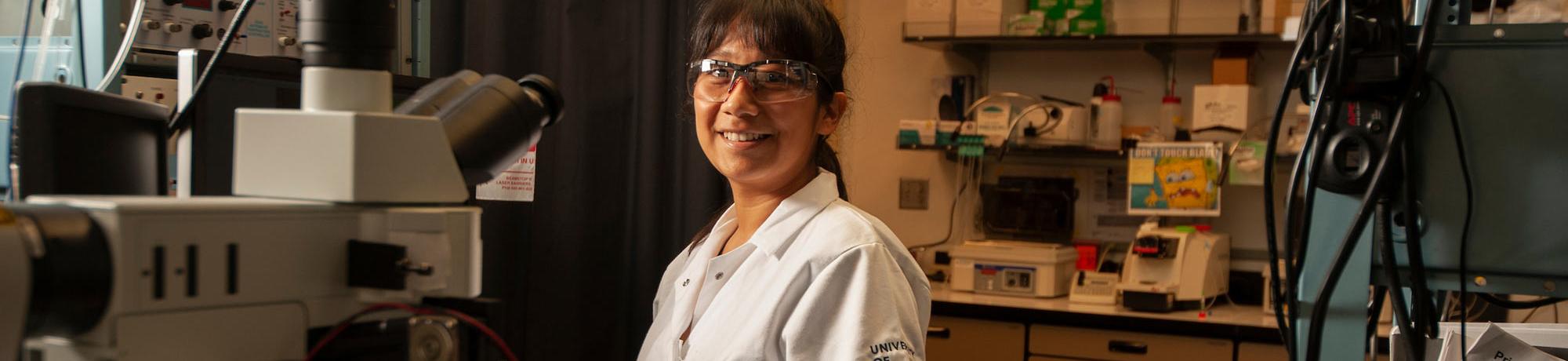 A female researcher smiles in her lab