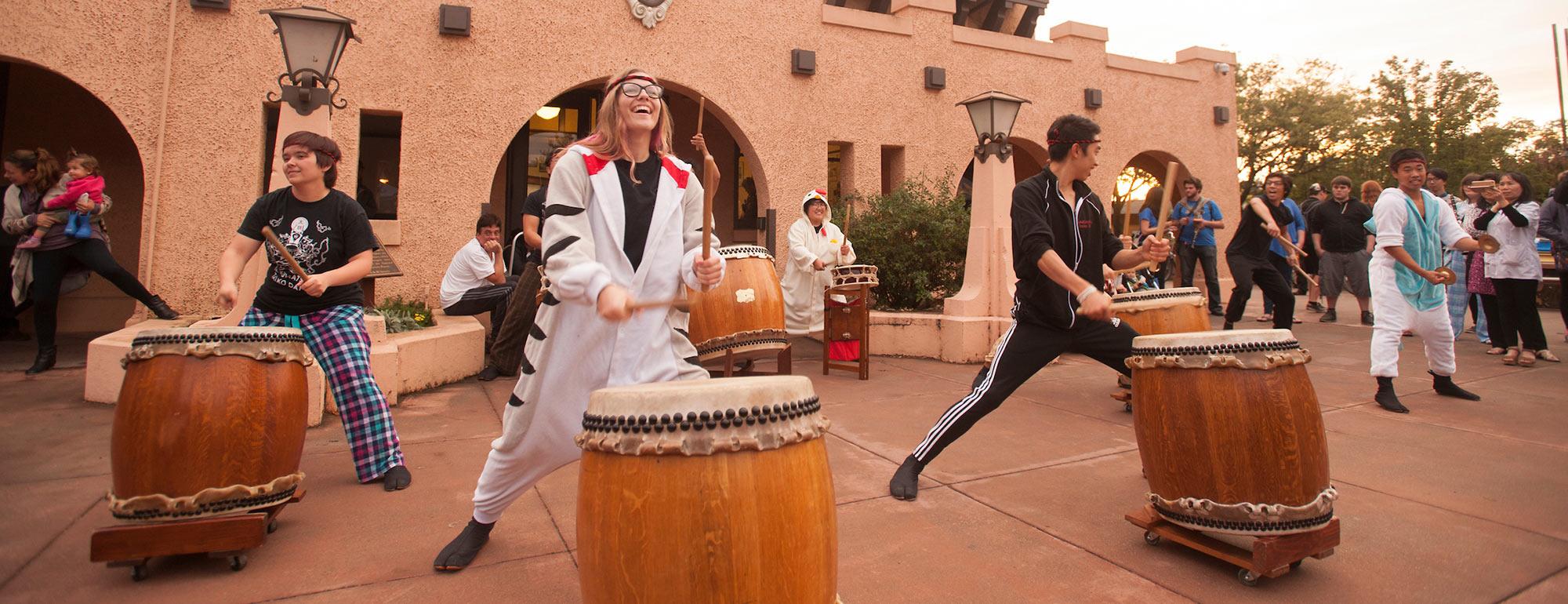 Three students drumming in their pajamas