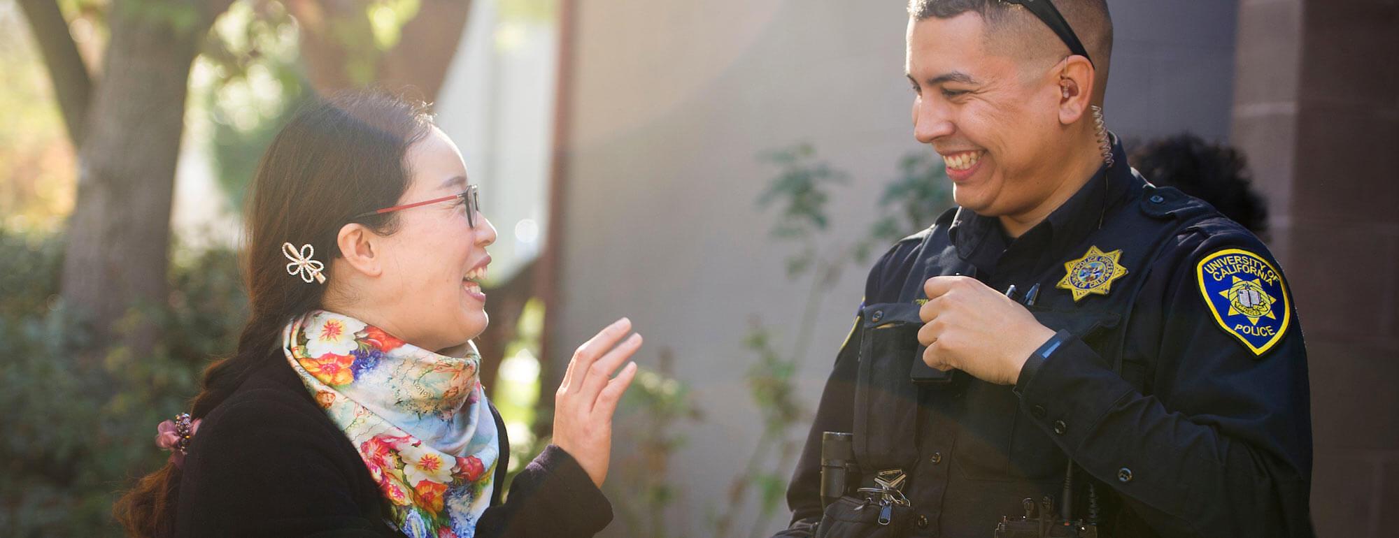 A campus police officer talks to one of our professors