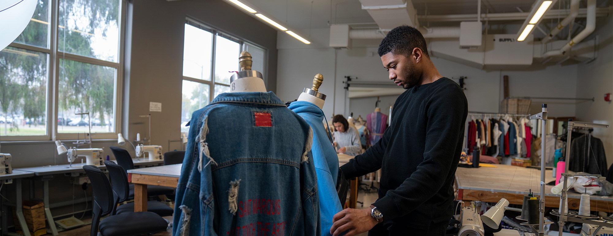 student working on a fashion design project in class