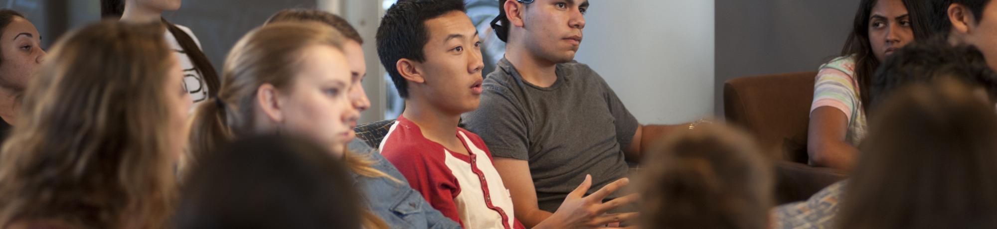 uc davis student answers a question in lecture as other students watch