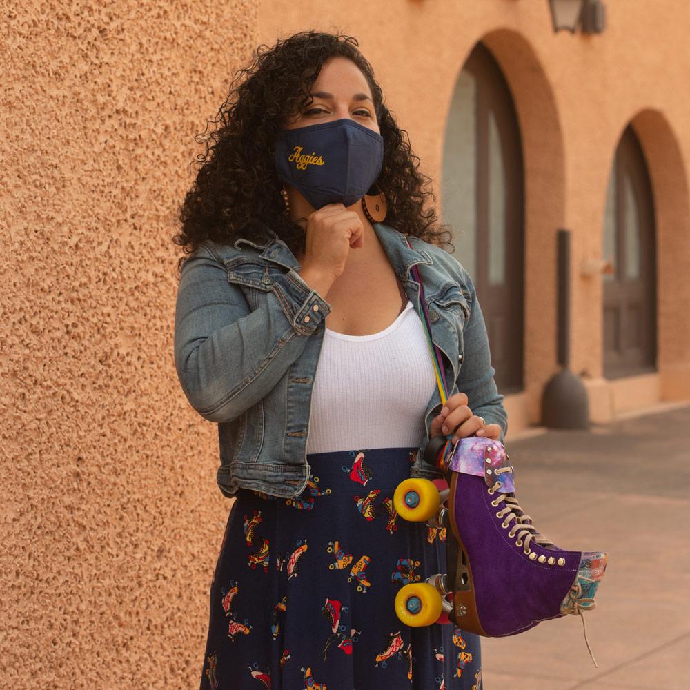 person standing in front of a building with a UC Davis mask