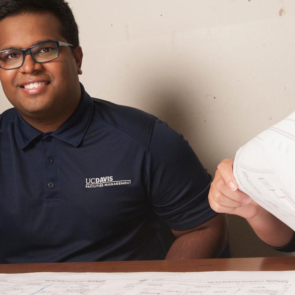 A student smiles over a city planning map