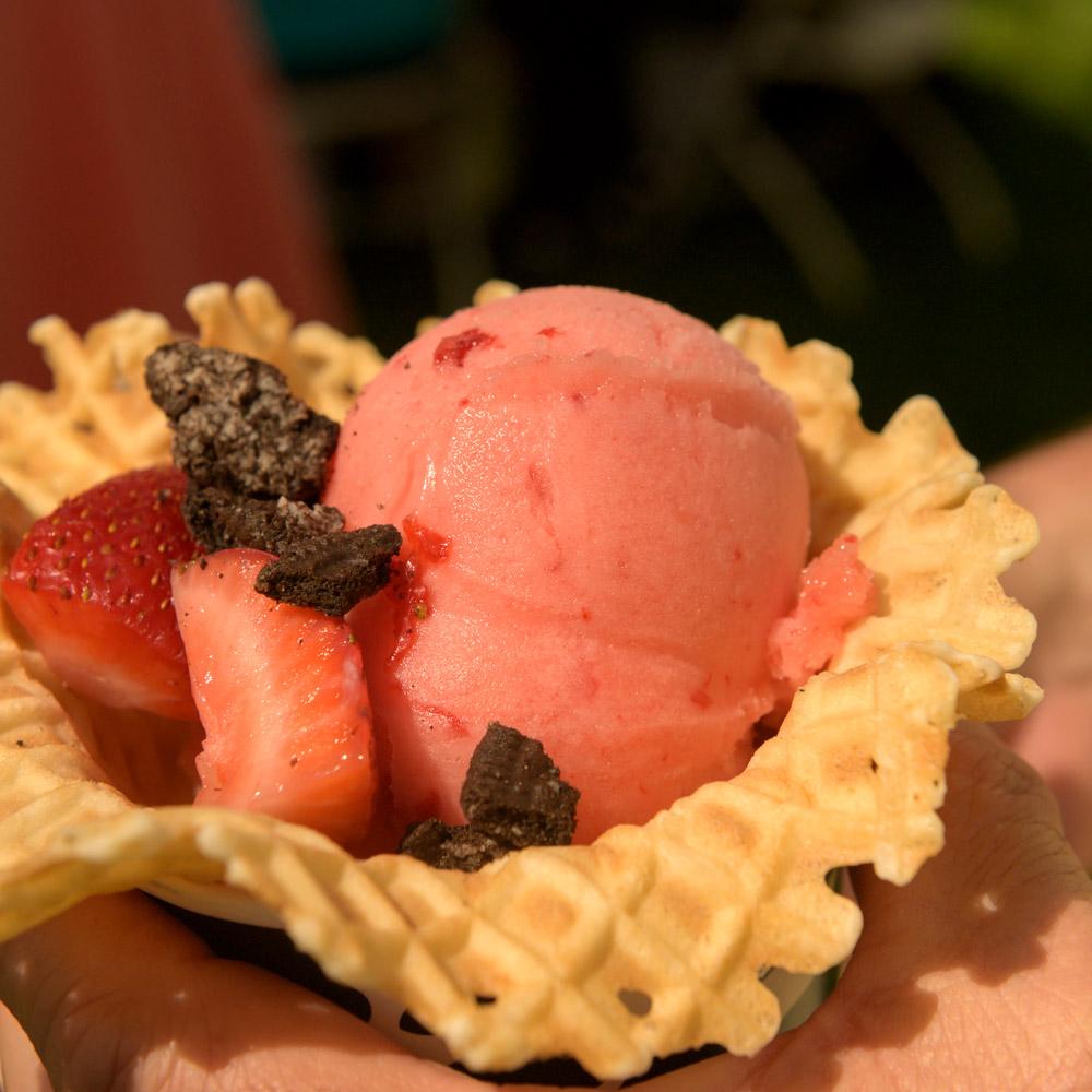 Close up on a waffle cone filled with strawberry ice cream