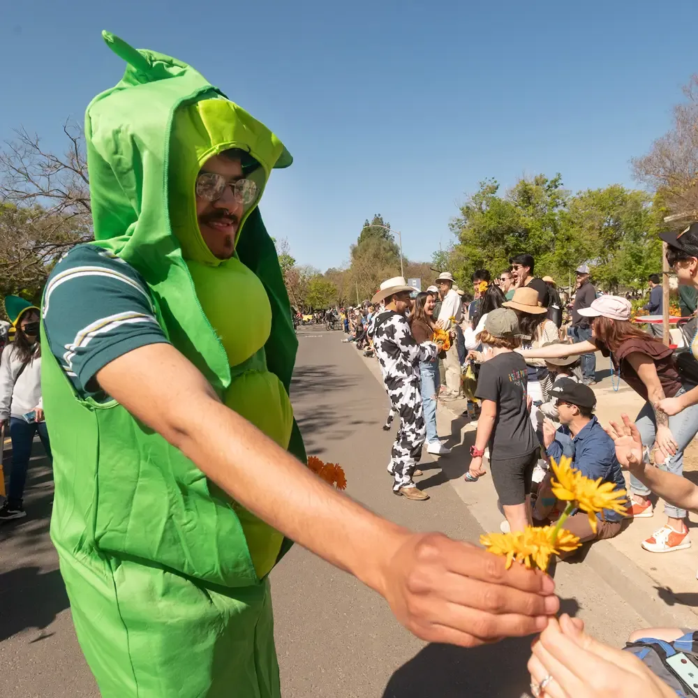 Students from the Student Farm hand out flowers to the crowd during Picnic Day