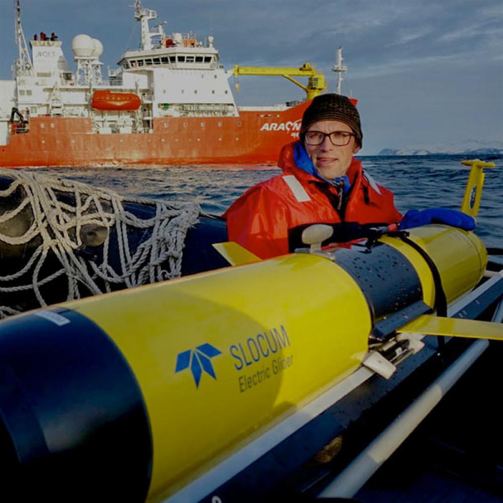 A UC Davis researcher works with a submersible that monitors ocean temperatures