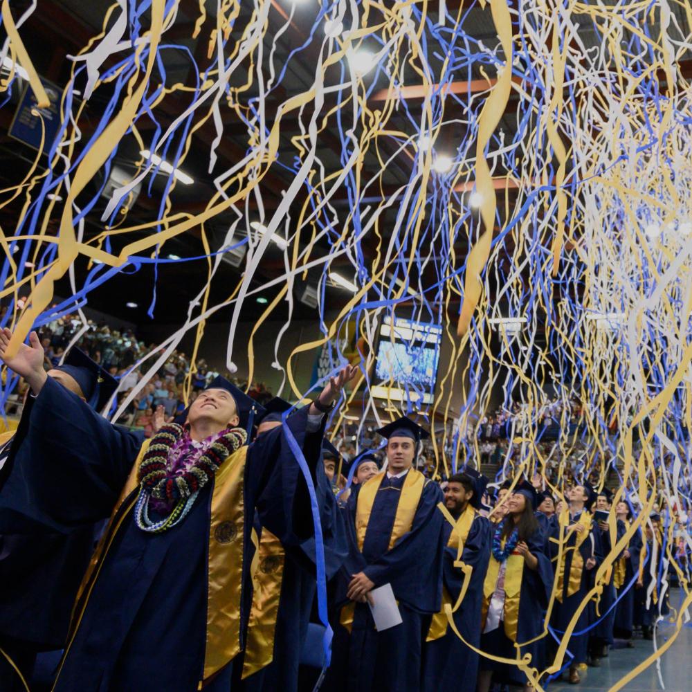 Streamers fall from the ceiling at the UC Davis Commencement ceremony