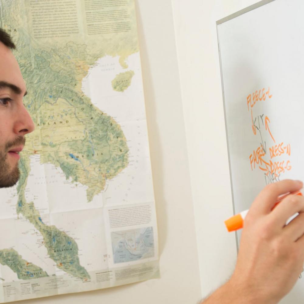 A PHD candidate evaluates word structure on a whiteboard