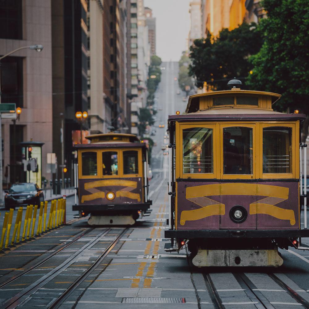Two cable cars travel up and down a San Francisco street
