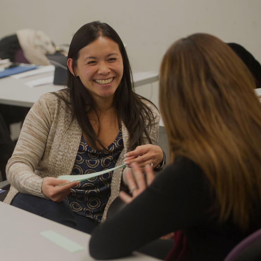 A smiling adviser assists a UC Davis student