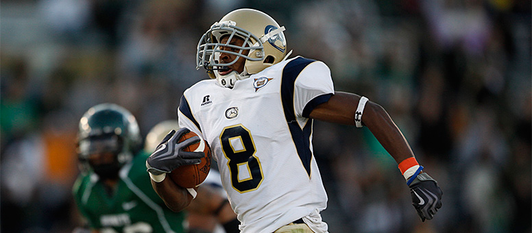 Aggie football player Bakari Grant carries the ball