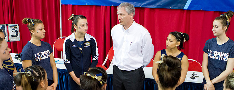 Coach John LaVallee talking to his gymnastics team