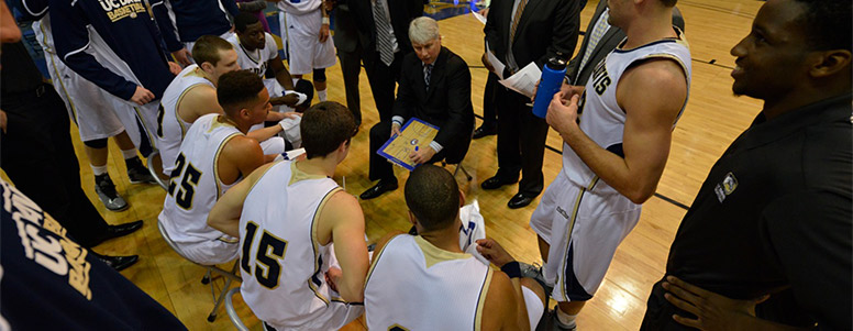 Basketball coach Jim Les talking to his team on the court