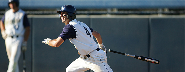 Baseball player throwing bat and beginning to run