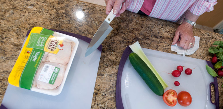  two cutting boards, one with the meat and the other with vegetables