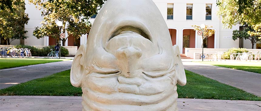 A sculpture of the "Fatal Laff" Egghead in front of Mrak Hall