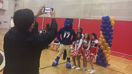 Gunrock and high school cherleaders pose for a photo