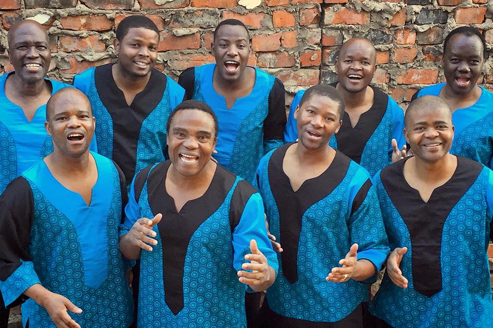 Nine members of the group all wearung blue shirts.