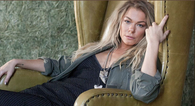 LeeAnn Rimes leaning back on a chair and staring into the camera.