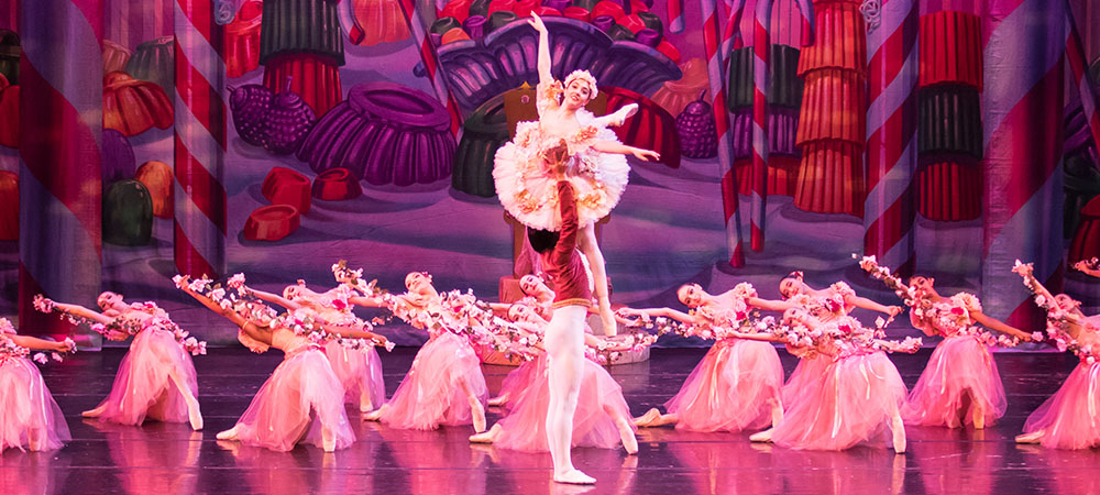 Ballet dancers on stage performing a scene from "The Nutcracker."