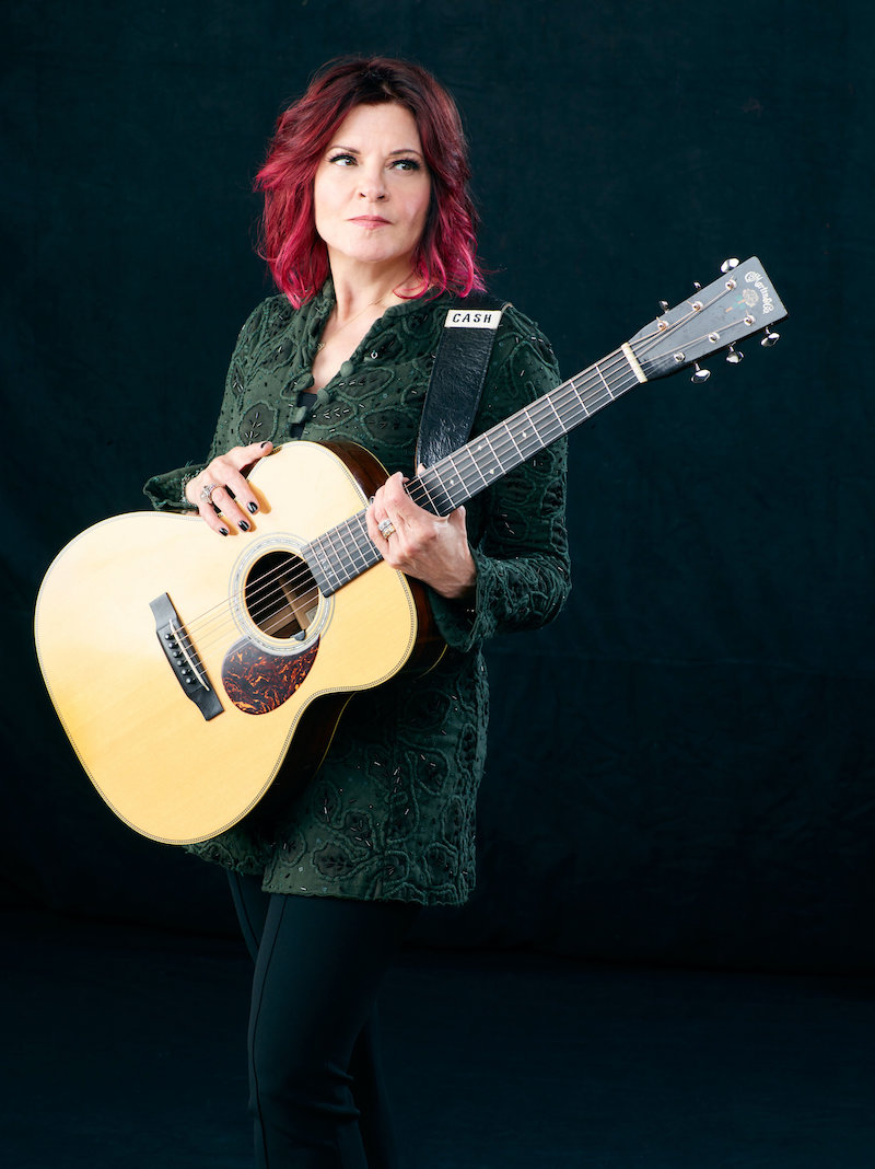 Rosanne Cash holding a guitar.